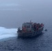 Coast Guard Cutter Healy small boat is anchored to an ice floe during cold water ice dive in the Arctic