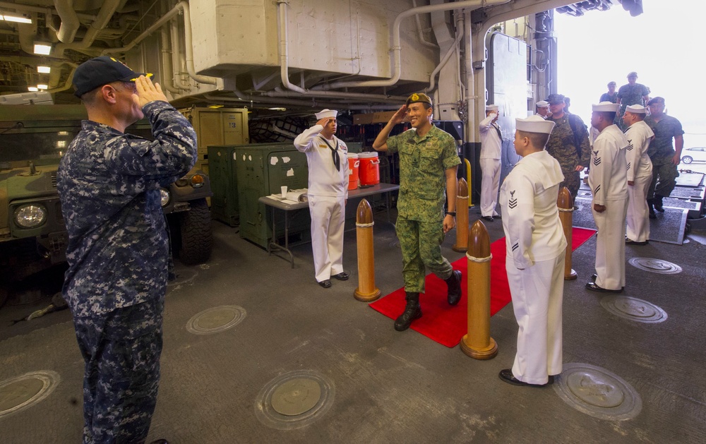 USS America Sailors greets Singaporean Officer