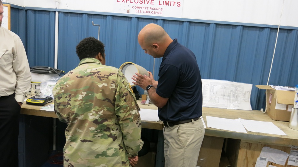 Travis Moore shows Letterkenny Munitions Center’s Advanced Anti-Radiation Guided Missile radome repair capabilities to CSM Tomeka O’Neal, Joint Munitions Command, while Brentley Gamble looks on.