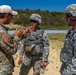 Sgt. Joseph Hall teaches Spc. Kenny Ochoa and Spc. Wantea Seong techniques with the M4 rifle