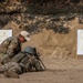 Sgt. Joseph Hall shows Staff Sgt. Jonathan Anderson how to improve accuracy with the M249 squad automatic weapon