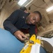 USS America Sailors ties down practice bomb