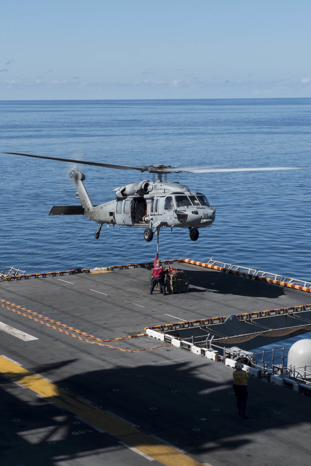 Sailros Hook Ordnance to an MH-60S Sea Hawk Aboard USS Bonhomme Richard (LHD 6)