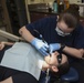 Hospital Corpsman Cleans Teeth