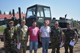 Romanian and U.S. leadership stand on soccer field developed for local community in Romania