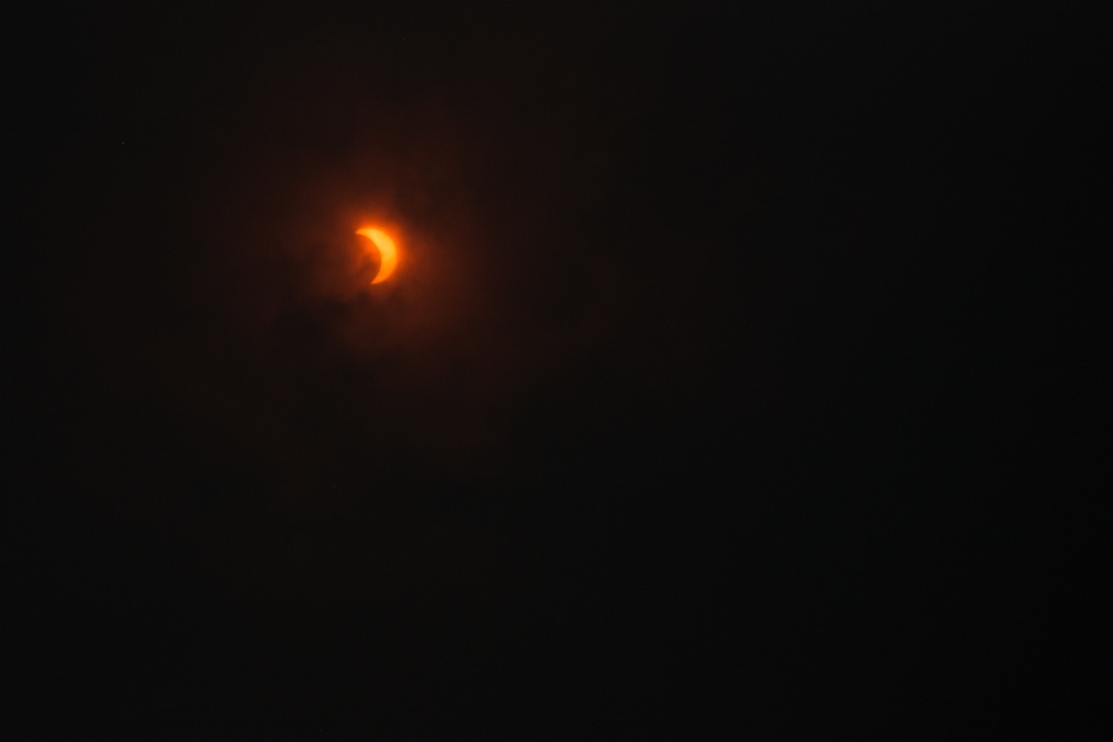 Eclipse appears during overcast skies