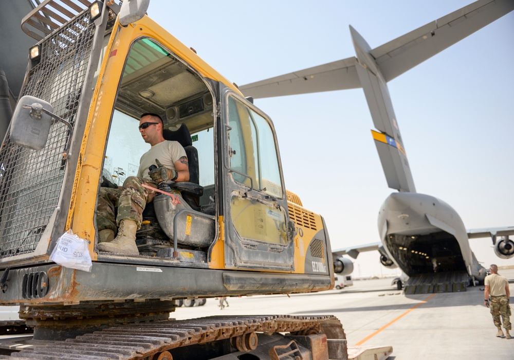 Heavy equipment loaded onto C-17 Globemaster III for transport across the AOR