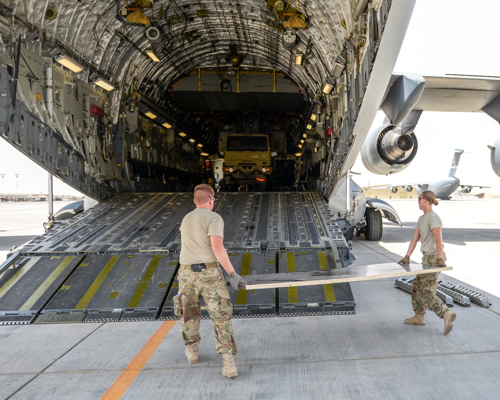 Heavy equipment loaded onto C-17 Globemaster III for transport across the AOR