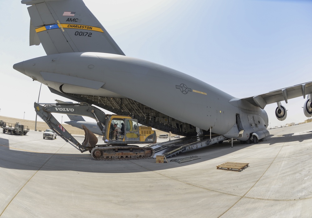 Heavy equipment loaded onto C-17 Globemaster III for transport across the AOR