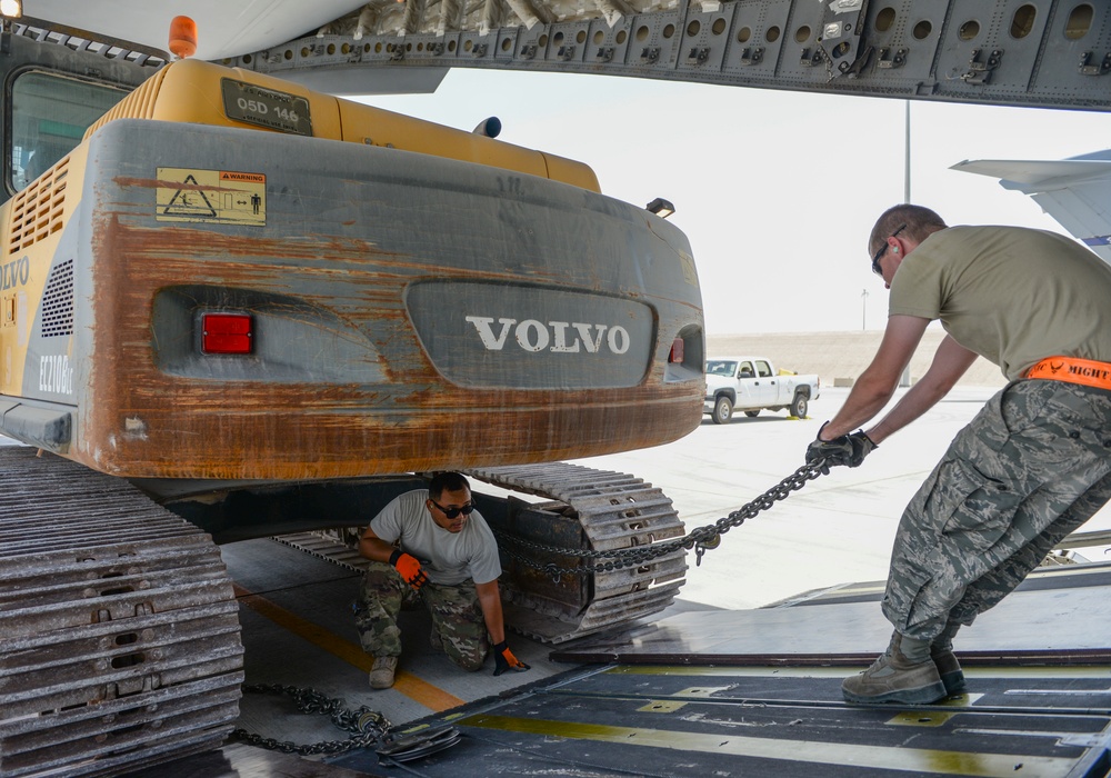 Heavy equipment loaded onto C-17 Globemaster III for transport across the AOR