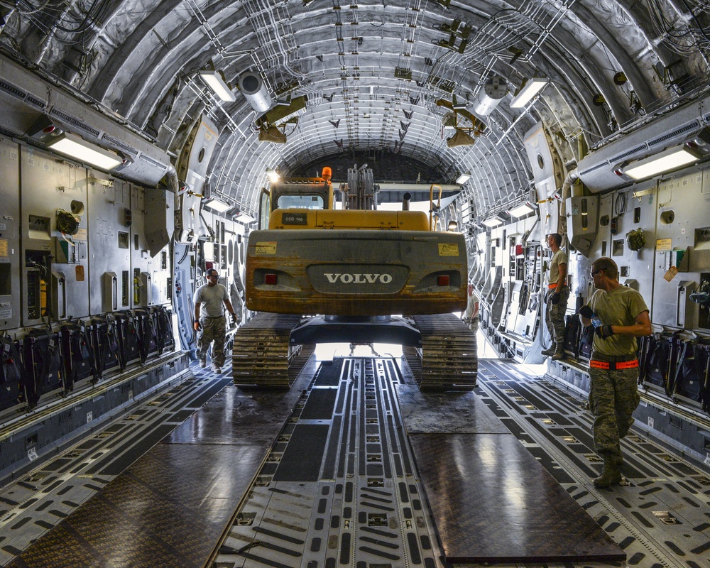 Heavy equipment loaded onto C-17 Globemaster III for transport across the AOR