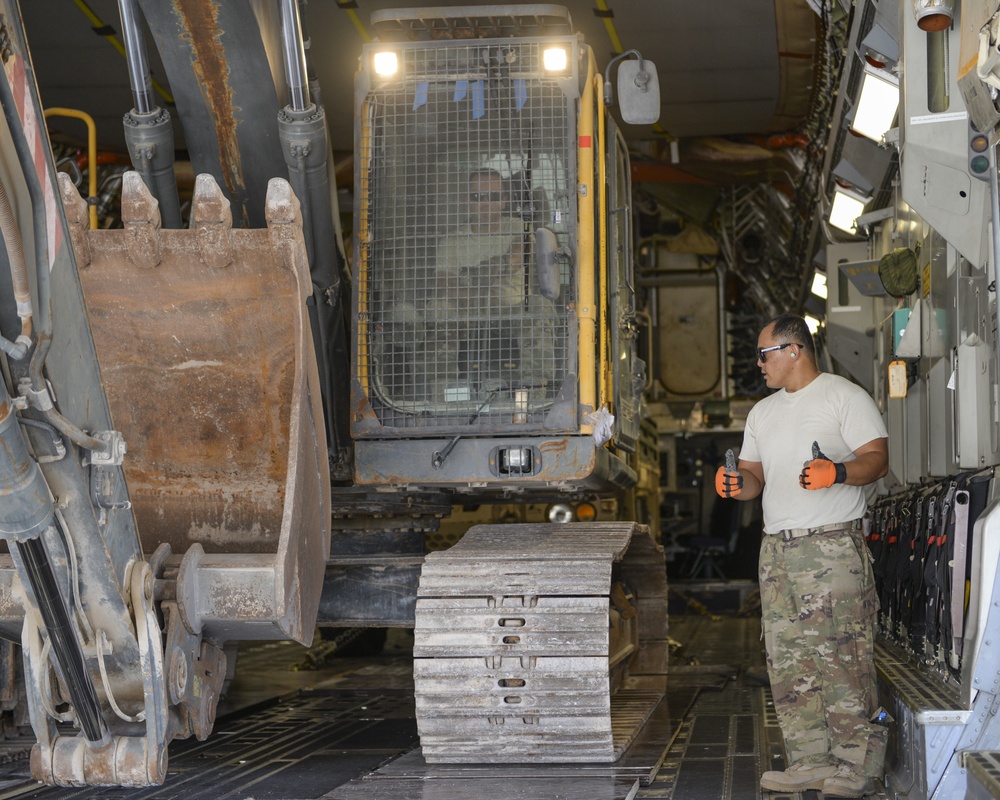 Heavy equipment loaded onto C-17 Globemaster III for transport across the AOR