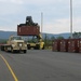 A Letterkenny Munitions Center employees unloads shipping containers from the 1148th Transportation Company, Georgia Army National Guard’s flatbed trailers in support of Operation Patriot Bandoleer.
