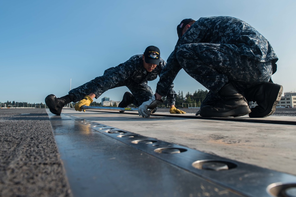 Sailors Perform Catapult Maintenance