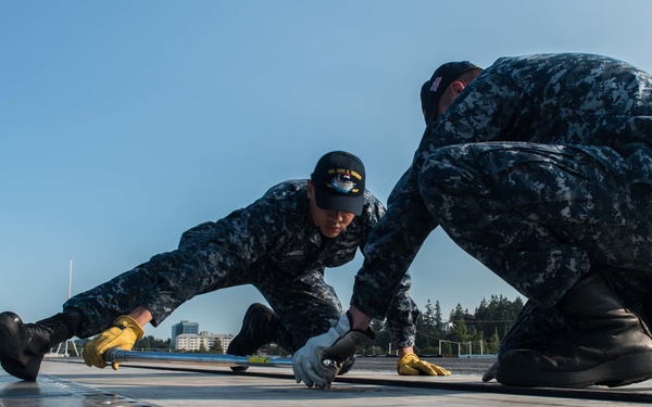 Sailors Perform Catapult Maintenance
