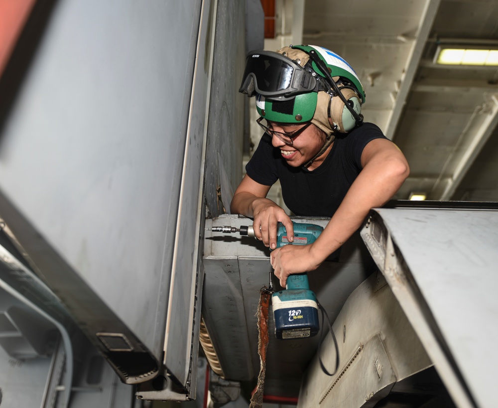 Sailor Performs Maintenance on Aircraft