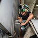Sailor Performs Maintenance on Aircraft