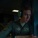 USAF-R C-17 loadmaster A1C Dakota Price assists pilot in chart navigaion