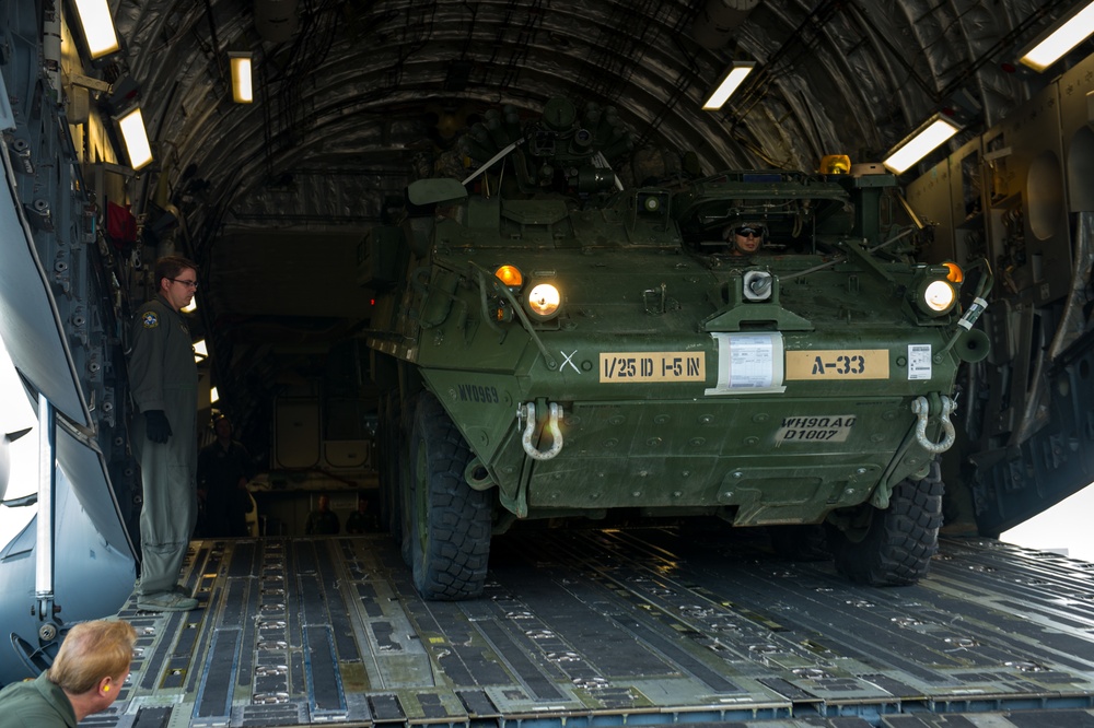 317th AS loadmasters unload Stryker IAV from C-17