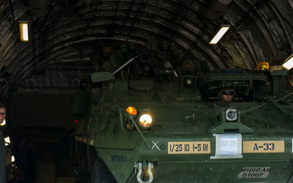 317th AS loadmasters unload Stryker IAV from C-17