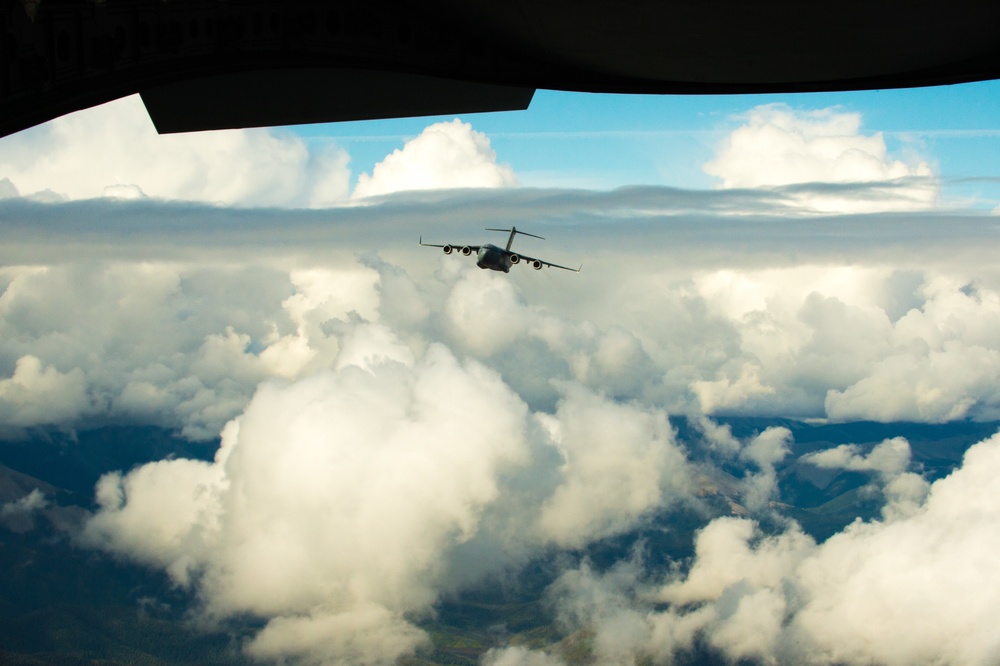 317th AS C-17 flying above the cloud cover north of JB Elmendorf-Richard, AK