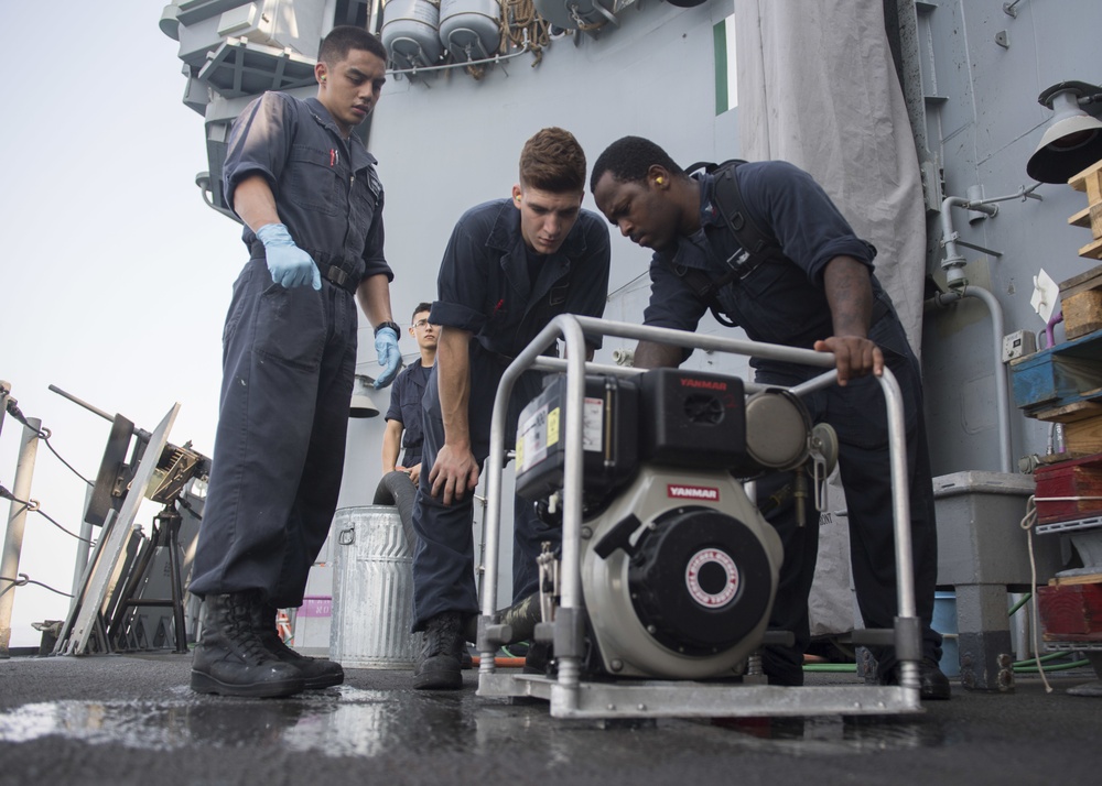 USS Lake Erie (CG 70) Sailors perform maintenance on the P-100
