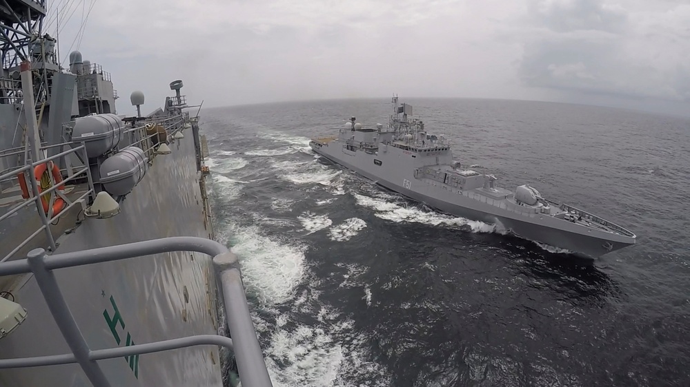 USS Pearl Harbor manuevers with the INS Trikand during live-fire gunnery exercise