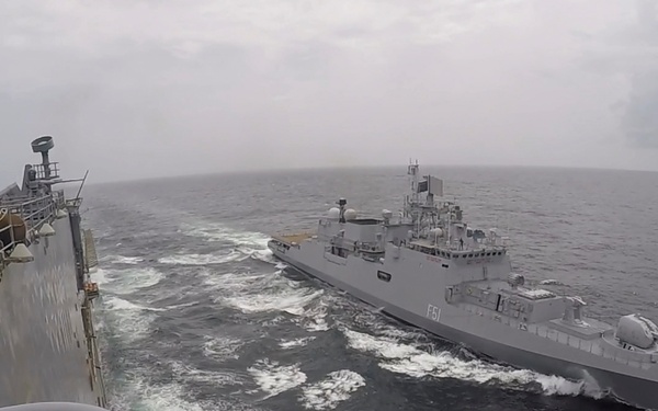 USS Pearl Harbor manuevers with the INS Trikand during live-fire gunnery exercise