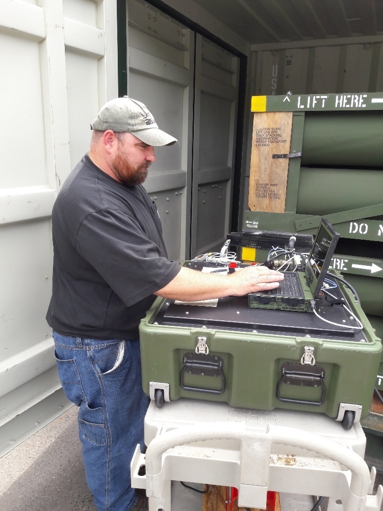 A Letterkenny Munitions Center employee uses a Mission Common Test Device to test Guided Multiple Launch Rocket Systems.  (Submitted photo.)