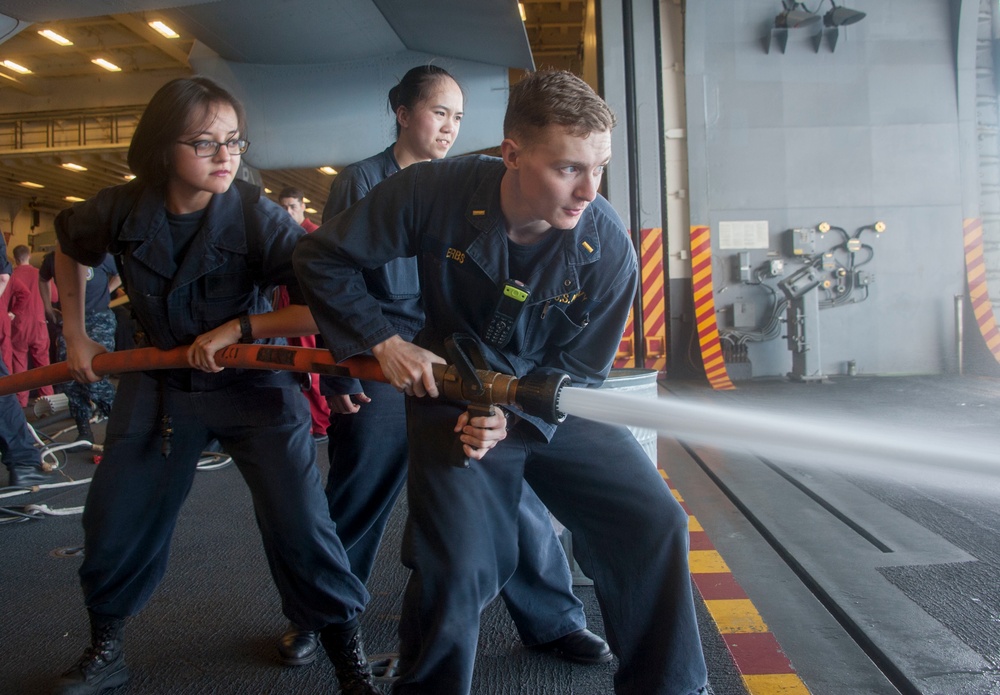 Sailors train with fire hose