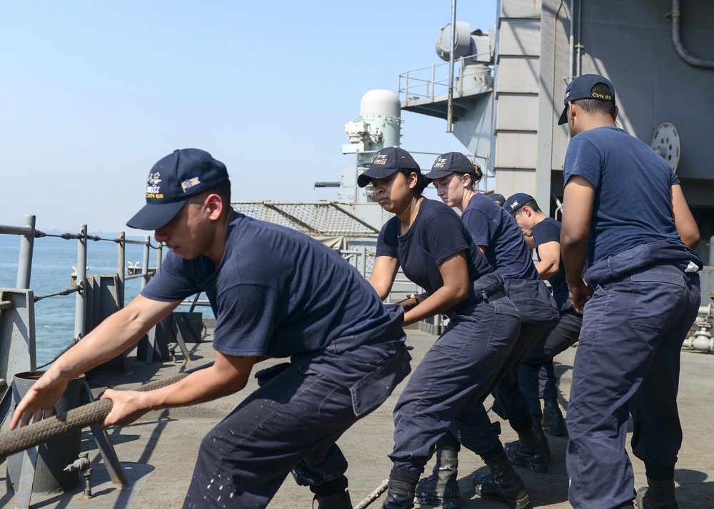 Sailors Heave On Mooring Line