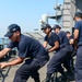 Sailors Heave On Mooring Line