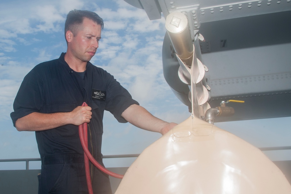 Sailor prepares to load missile