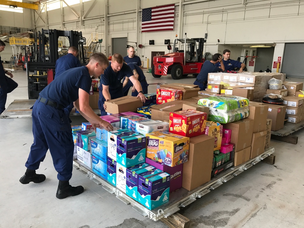Coast Guard crews prepare supplies for Hurricane Harvey relief