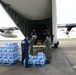 A Coast Guard Air Station Elizabeth City HC-130 aircrew and Marine Safety Unit Port Arthur personnel offload bottled water to aid families affected by Hurricane Harvey