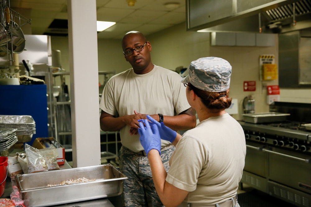 Members of 147th Force Support Squadron prepares meals at Ellington