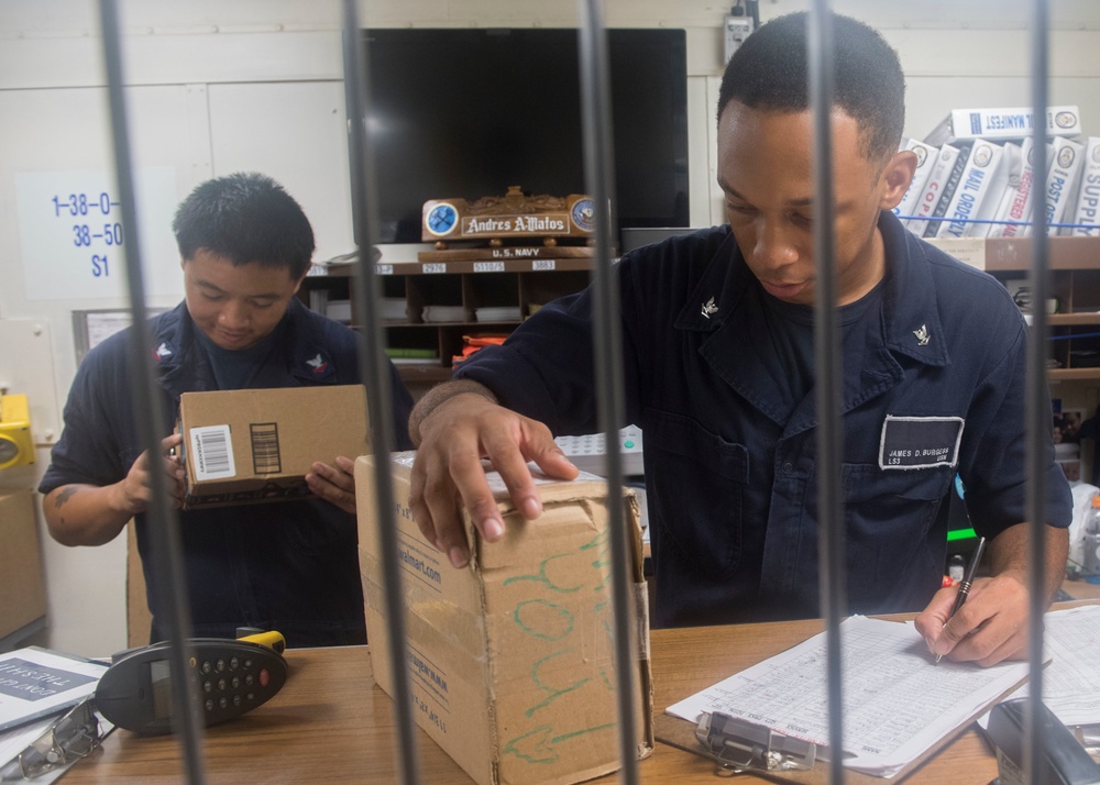 USS Lake Erie (CG 70) Sailors process incoming mail