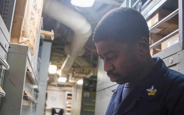 USS Lake Erie (CG 70) Sailor does inventory