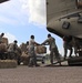 Texas Military Department soldiers and airmen load hay bales as part of Operation Hay Drop