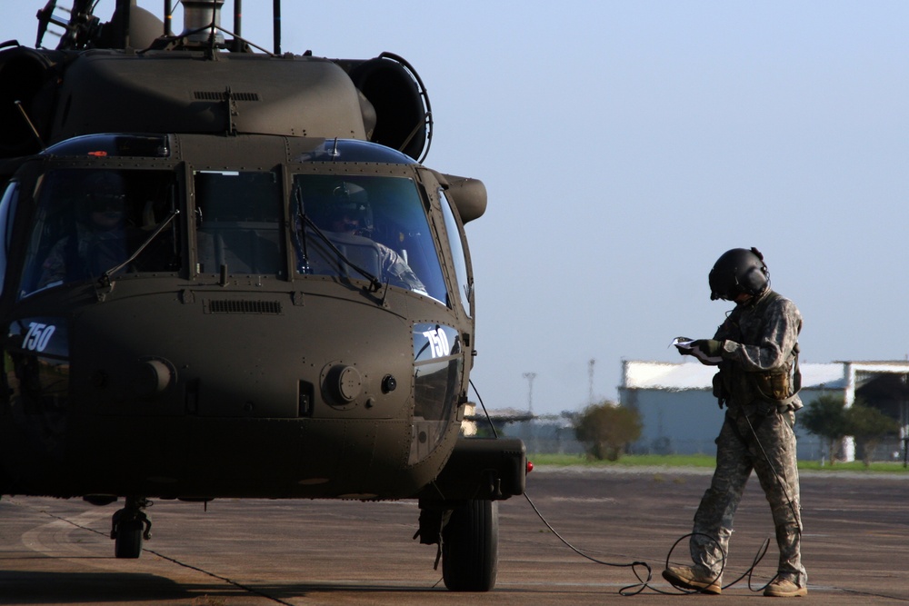 Texas Military Department soldiers and airmen load hay bales as part of Operation Hay Drop