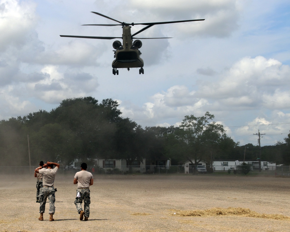 Texas Military Department soldiers and airmen load hay bales as part of Operation Hay Drop