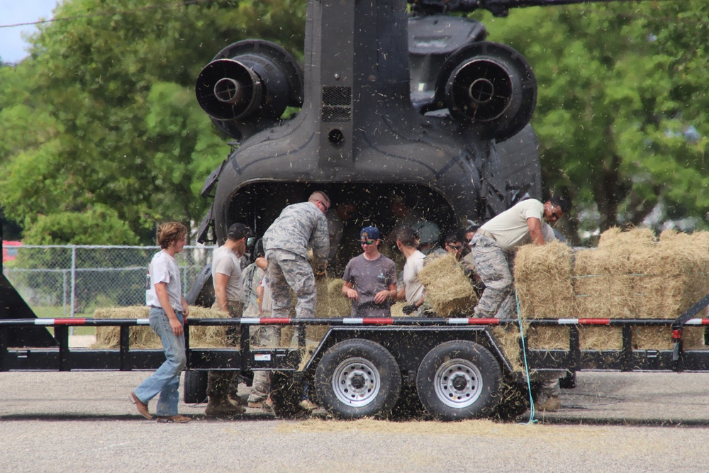 Texas Military Department soldiers and airmen load hay bales as part of Operation Hay Drop