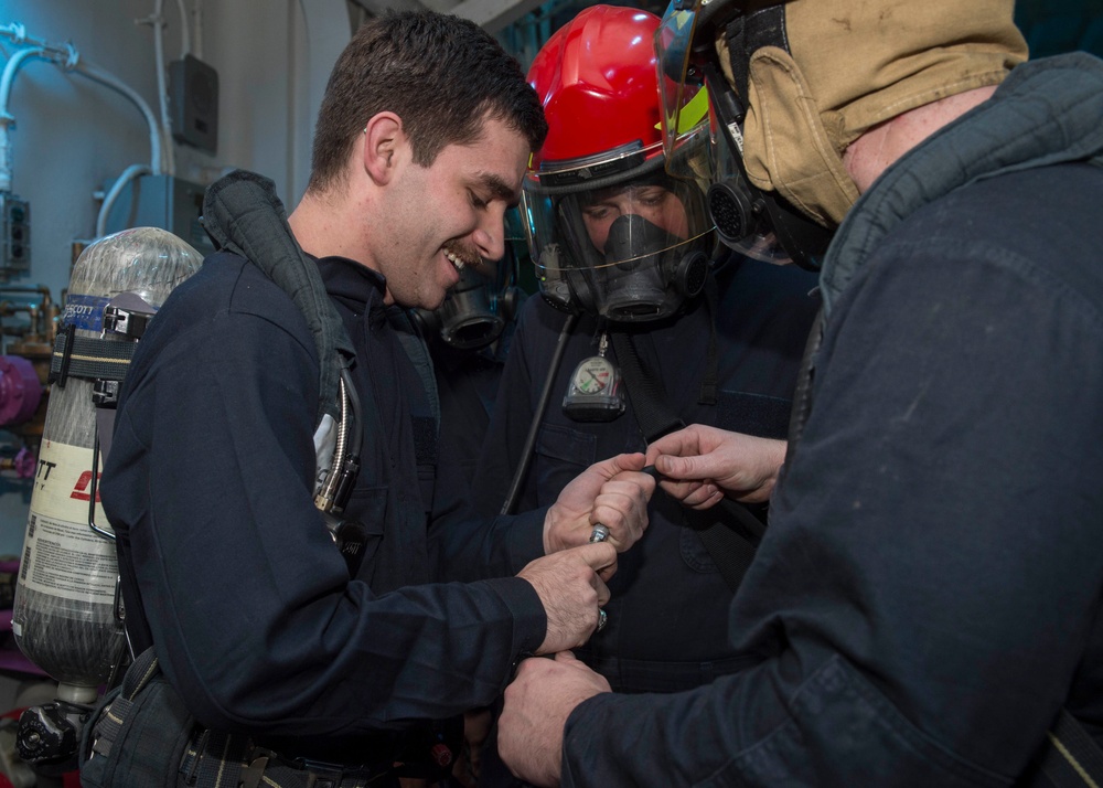 Sailors assigned to the amphibious assault ship USS Bonhomme Richard (LHD 6) take part in an at-sea fire party drill.
