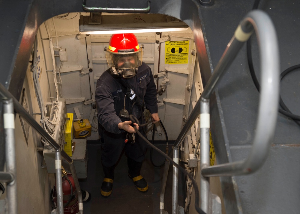 Sailors assigned to the amphibious assault ship USS Bonhomme Richard (LHD 6) take part in an at-sea fire party drill.