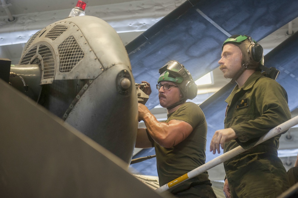 Marines conduct maintenance on a CH-53E Super Stallion helicopter