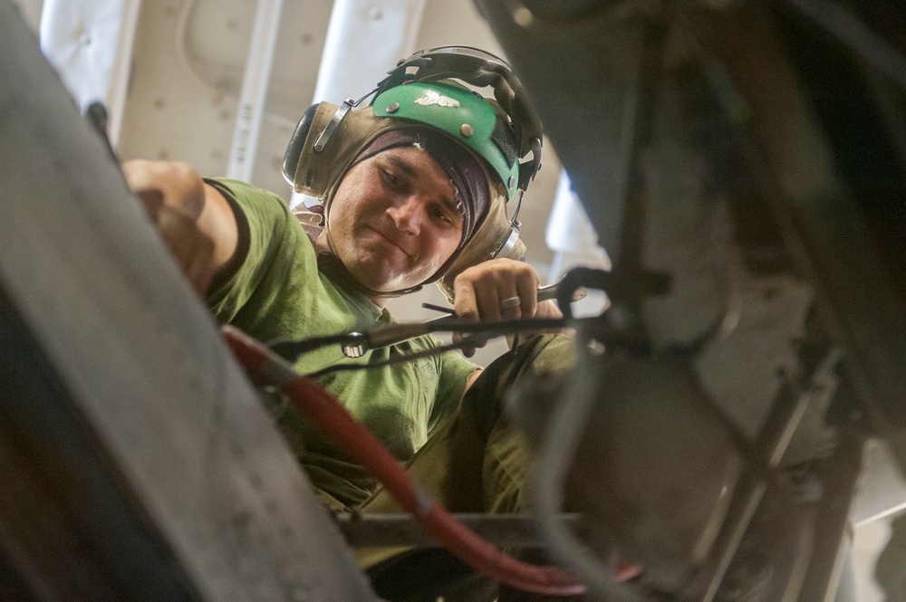 Marines conduct maintenance on a CH-53E Super Stallion helicopter