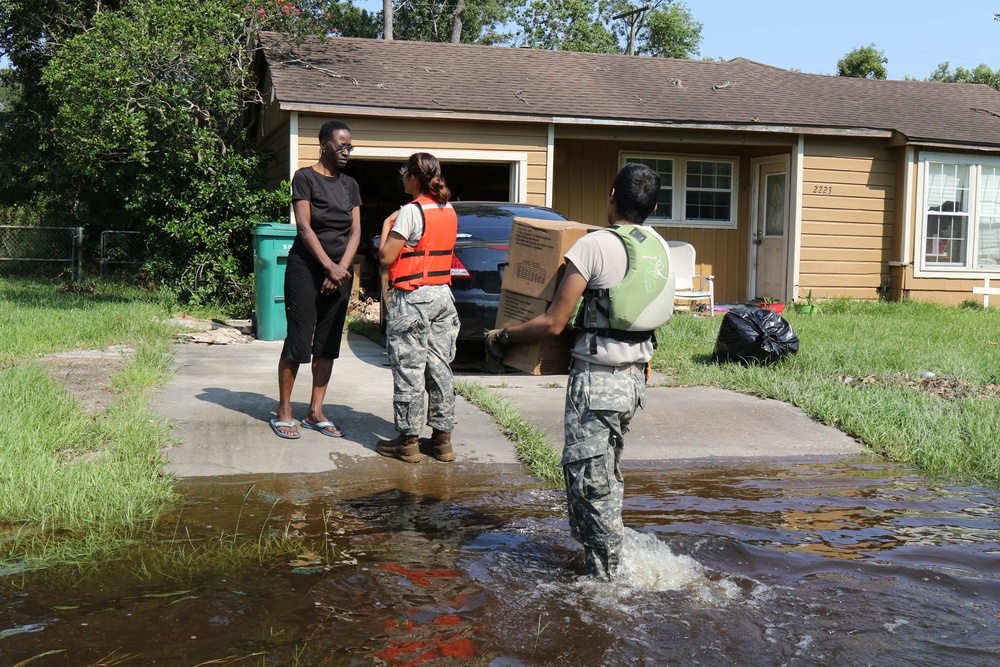 Texas National Guard Soldiers distribute food and supplies to stranded residents in Orange