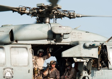 Sailor directs a helicopter for take off