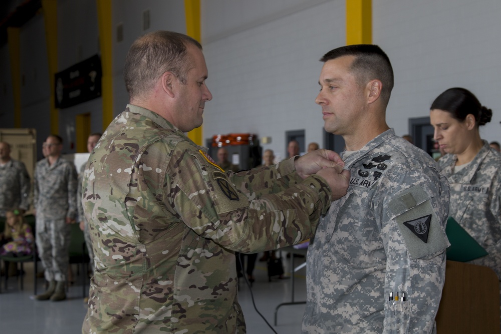 Brigade Commander pins Meritorious Service Medal onto Outgoing Battalion Commander
