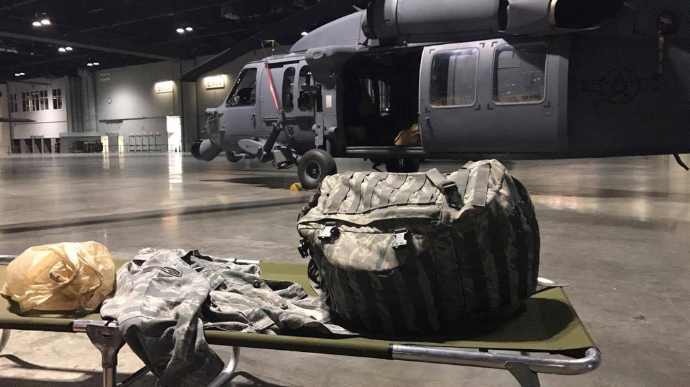 Air Force reservists camp out next to rescue heliocpters during Hurricane Irma